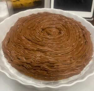 A homemade cake with chocolate frosting.